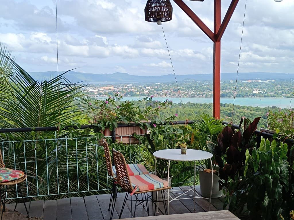 Balcony seating overlooking tropical hills and the sea